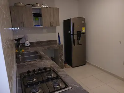 a kitchen with a stove and a refrigerator at Casa Marbella in Cartagena de Indias