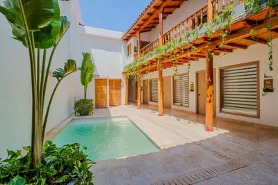 a swimming pool in the courtyard of a house at CASA EMMA HOTEL Boutique in Cartagena de Indias