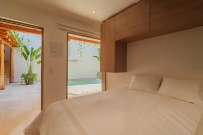 a bedroom with a bed and a sliding glass door at CASA EMMA HOTEL Boutique in Cartagena de Indias