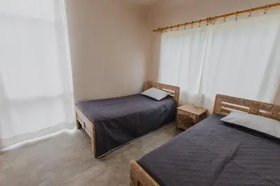 a bedroom with two beds and a window at Apartamento Atlantic 212 in La Perdiz