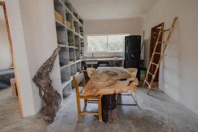 a dining room with a table and a kitchen with a refrigerator at Apartamento Atlantic 212 in La Perdiz