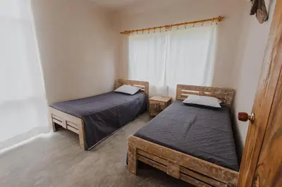 two twin beds in a room with a window at Apartamento Atlantic 212 in La Perdiz