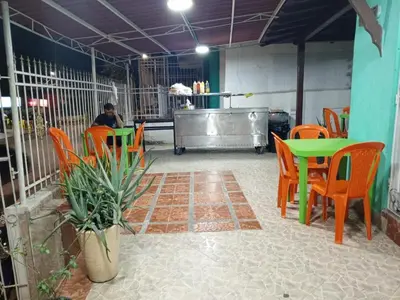 a person sitting at a table in a restaurant at Sharly House in Cartagena de Indias