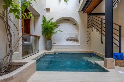 a swimming pool in the middle of a house at Casa Fernandez By SoHo in Cartagena de Indias