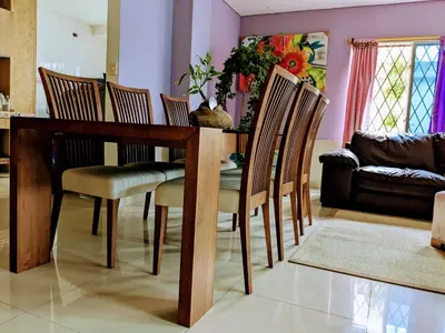 a dining room table with chairs and a couch at Me Quedo Aqui, Casa Cerca del Aeropuerto de Cartagena! in Cartagena de Indias