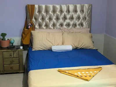a bedroom with a large bed with a large headboard at Me Quedo Aqui, Casa Cerca del Aeropuerto de Cartagena! in Cartagena de Indias