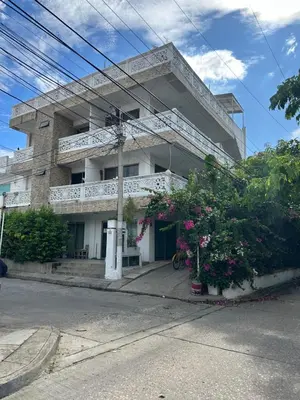 a white building with flowers in front of it at Casona La Española in Cartagena de Indias