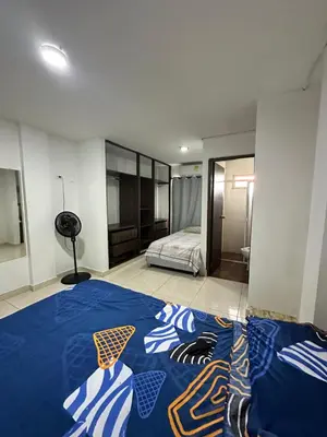 a bedroom with a blue comforter on a bed at Casona La Española in Cartagena de Indias