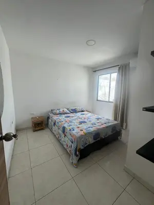 a bedroom with a bed in a room with a window at Casona La Española in Cartagena de Indias
