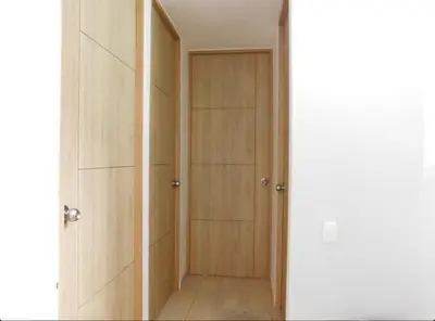 a closet with wooden doors in a room at Apartamento en alameda del Río Conjunto Azulejo in Barranquilla