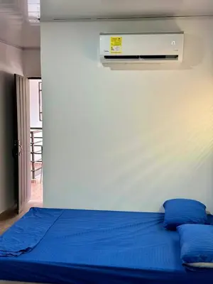 a bedroom with a bed with blue sheets and a heater at Hostal tercer cielo Restaurante Fidelio in Santa Marta
