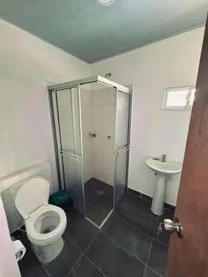 a bathroom with a shower and a toilet and a sink at Hostal tercer cielo Restaurante Fidelio in Santa Marta