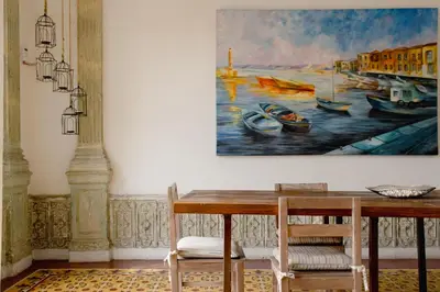 a dining room with a painting on the wall at Casa Guerrero in Cartagena de Indias
