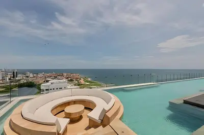 a swimming pool with a view of the ocean at Vista Centro Histórico Piso 21 Piscina Infinita in Cartagena de Indias