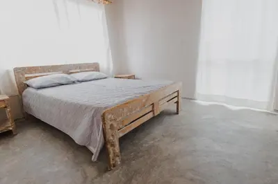 a bedroom with a bed with a wooden frame at Apartamento Atlantic 312 in La Perdiz