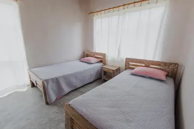 two beds in a room with a window at Apartamento Atlantic 312 in La Perdiz