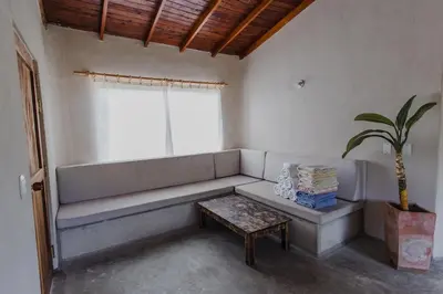 a living room with a couch and a potted plant at Apartamento Atlantic 312 in La Perdiz