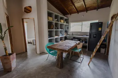a kitchen with a table and chairs and a refrigerator at Apartamento Atlantic 312 in La Perdiz