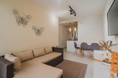 a living room with a couch and butterflies on the wall at Apartamento de 3 habitaciones en Cartagena cerca a la playa in Cartagena de Indias