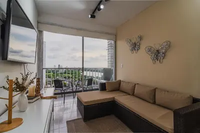 a living room with a couch and butterflies on the wall at Apartamento de 3 habitaciones en Cartagena cerca a la playa in Cartagena de Indias