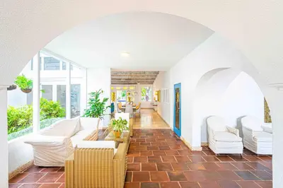 a large living room with white furniture and windows at Luxury Bryon Pool in Cartagena de Indias