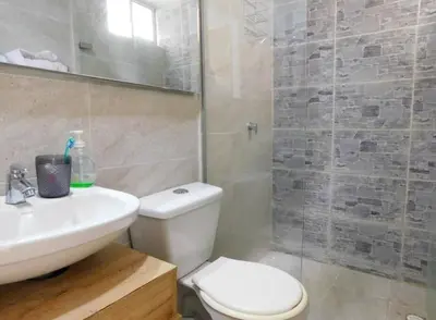 a bathroom with a toilet and a sink and a shower at Apartamento en alameda del Río in Barranquilla