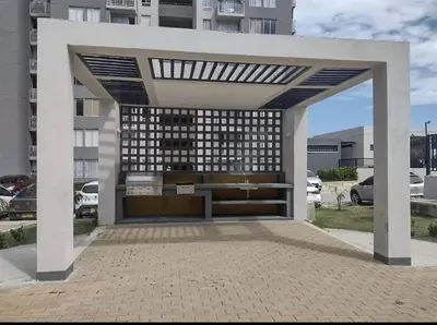 a building with a large garage with a building at Apartamento en alameda del Río in Barranquilla
