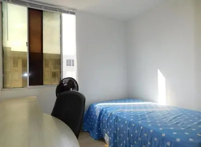 a small bedroom with a bed and a window at Apartamento en alameda del Río in Barranquilla
