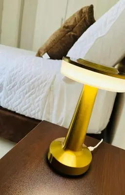 a yellow lamp on a table next to a bed at Tropical Oasis Barranquilla in Barranquilla