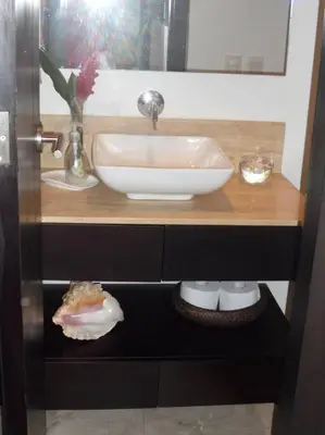 a bathroom counter with a white sink and a bowl at Charming 1BR apartment in the Heart of Cartagena's Old City in Cartagena de Indias