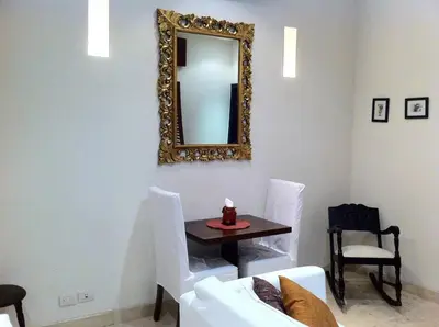 a living room with a table and a mirror at Charming 1BR apartment in the Heart of Cartagena's Old City in Cartagena de Indias