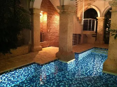 a swimming pool with blue tiles in a building at Charming 1BR apartment in the Heart of Cartagena's Old City in Cartagena de Indias