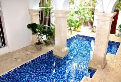 a swimming pool with blue tiles in a house at Charming 1BR apartment in the Heart of Cartagena's Old City in Cartagena de Indias