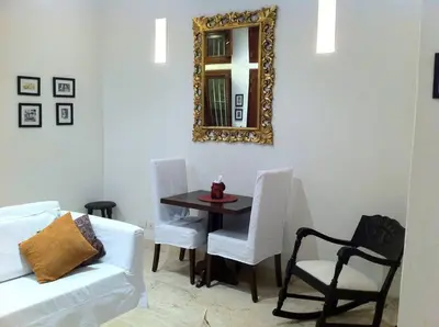 a living room with a table and a mirror at Charming 1BR apartment in the Heart of Cartagena's Old City in Cartagena de Indias