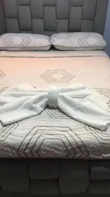 a bed with a shirt and a bow tie on it at El reposo real in Barranquilla