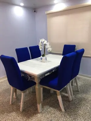 a conference room with a table and blue chairs at El reposo real in Barranquilla
