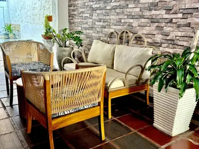 a living room with rattan chairs and a couch at Casa Centro Historico Hotel in Cartagena de Indias