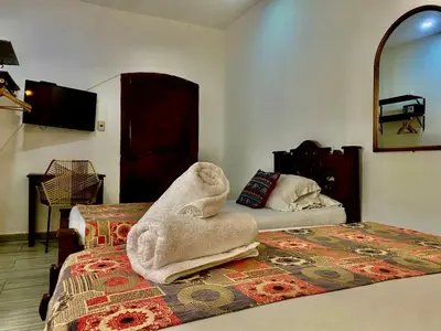a bedroom with a bed with a towel animal on it at Casa Centro Historico Hotel in Cartagena de Indias