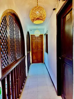 a hallway with a wooden door and a tile floor at Casa Centro Historico Hotel in Cartagena de Indias