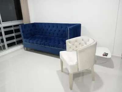 a blue couch and a white chair in a room at Apartamento Manglar C Mallorquin Vista al Mar in Puerto Colombia