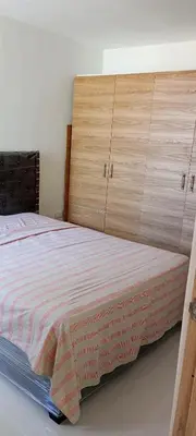 a bedroom with a bed with a wooden headboard at Apartamento Manglar C Mallorquin Vista al Mar in Puerto Colombia