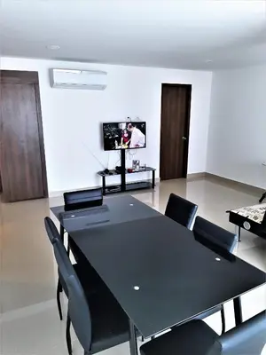 a dining room with a black table and chairs at Appartamento Italian Style in Cartagena de Indias