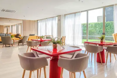 a dining room with red tables and chairs at Exclusive Loft In Cartagena By Huepedia in Cartagena de Indias