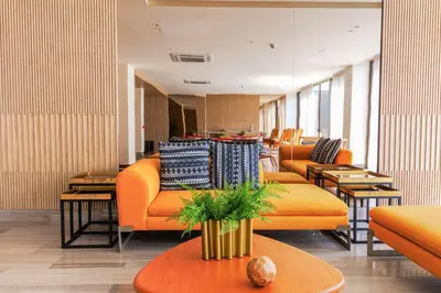 a store with orange couches and tables in a room at Exclusive Loft In Cartagena By Huepedia in Cartagena de Indias