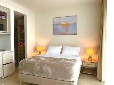 a bedroom with a large bed and two lamps at Exclusive Loft In Cartagena By Huepedia in Cartagena de Indias