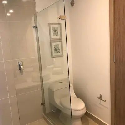 a bathroom with a toilet and a glass shower at New Apartment 2BR In Morros ECO in Bolivar