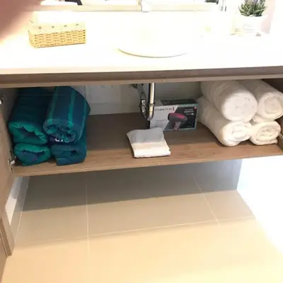 a shelf under a bathroom sink with towels on it at New Apartment 2BR In Morros ECO in Bolivar