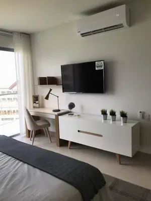 a bedroom with a desk and a tv on a wall at New Apartment 2BR In Morros ECO in Bolivar