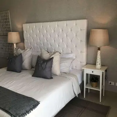 a bedroom with a large white bed with two lamps at New Apartment 2BR In Morros ECO in Bolivar