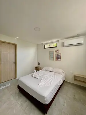 a bedroom with a large bed with white sheets at Hotel La Estrella de David Cartagena in Cartagena de Indias